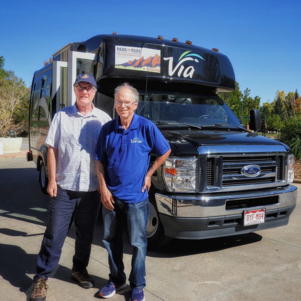 Two men standing in front of a Via Mobility Services paratransit vehicle in Boulder, Colorado