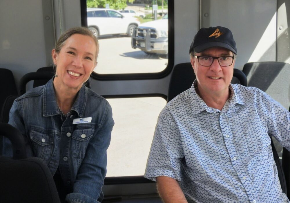 Via Mobility Services staff member and a ride-along guest seated on a Via paratransit vehicle during Week Without Driving 2026 in Boulder